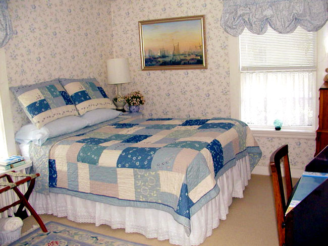 Cozy full bed with blue coloring throughout.